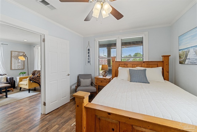 bedroom featuring ceiling fan, wood finished floors, visible vents, and crown molding