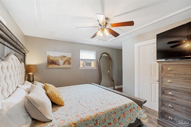 bedroom featuring ceiling fan, cooling unit, and wood-type flooring