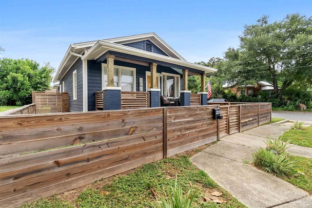 view of front of home featuring a porch and a fenced front yard