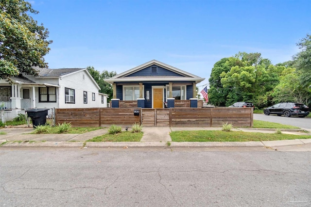 view of front of house with a fenced front yard and a gate