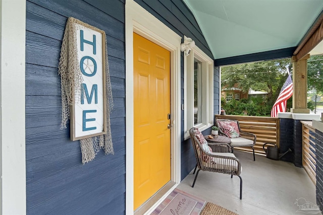 view of exterior entry with a porch