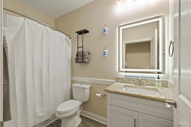 bathroom with hardwood / wood-style flooring, vanity, and toilet