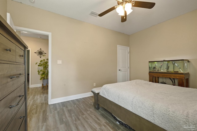 bedroom with hardwood / wood-style floors and ceiling fan