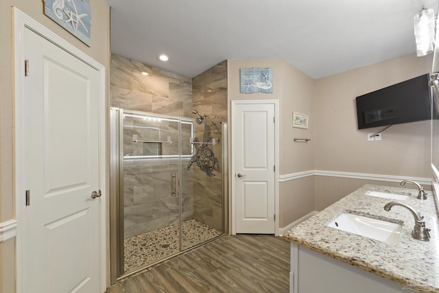 bathroom featuring vanity, wood-type flooring, and an enclosed shower