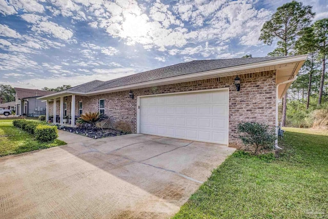 single story home featuring a garage and a front lawn