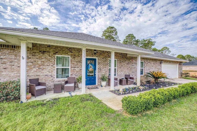 property entrance with a garage, a lawn, and central AC