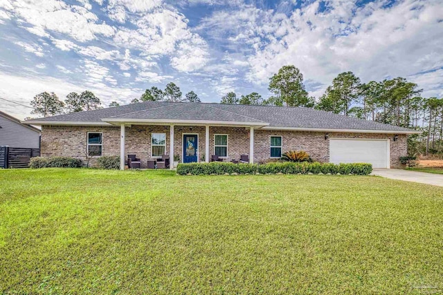 ranch-style house featuring a garage, a front yard, and covered porch