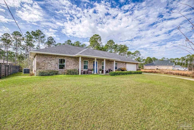 single story home featuring a garage, central AC, and a front yard