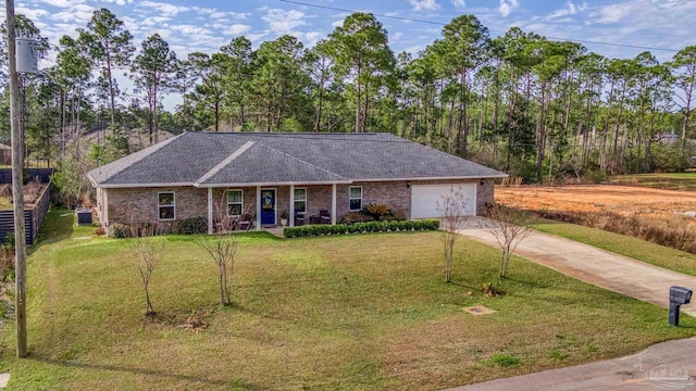 single story home with a garage, covered porch, and a front lawn