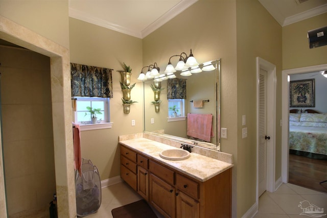 full bath featuring tile patterned flooring, ornamental molding, baseboards, and vanity