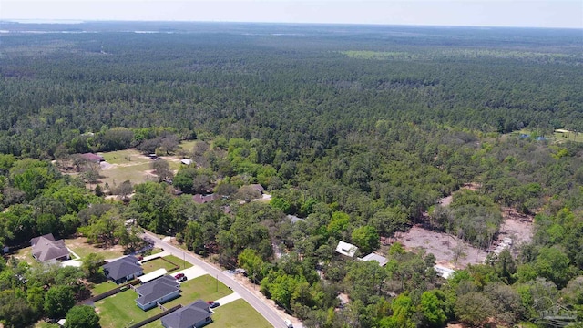 drone / aerial view with a wooded view