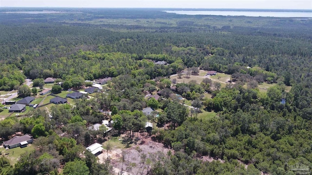 birds eye view of property with a view of trees