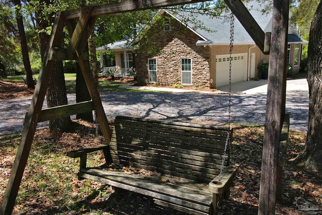 view of yard featuring an attached garage and concrete driveway