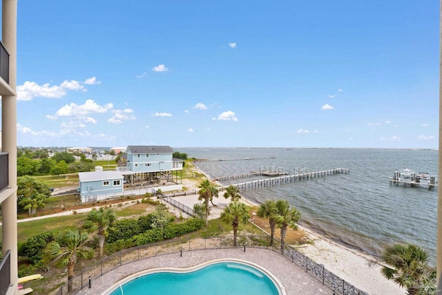 view of swimming pool featuring a water view