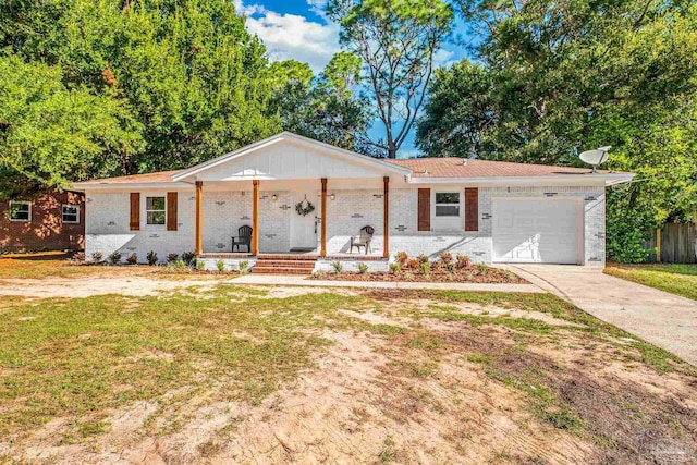 ranch-style house featuring covered porch, a garage, and a front yard