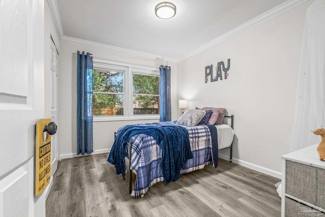 bedroom featuring wood-type flooring and crown molding