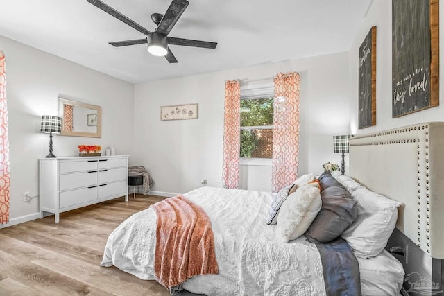 bedroom with ceiling fan and light hardwood / wood-style floors