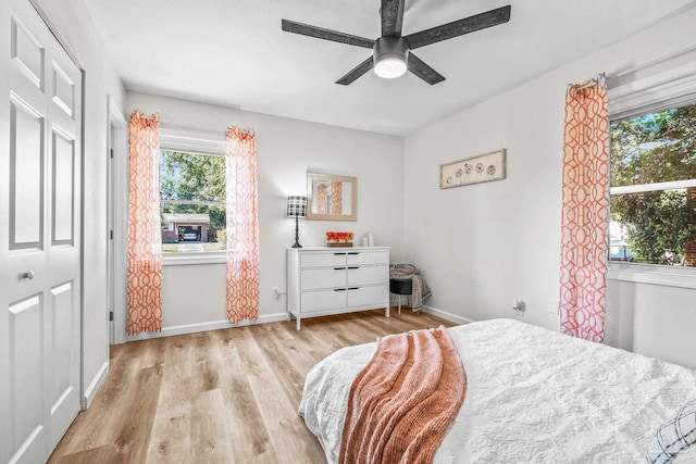 bedroom featuring a closet, light hardwood / wood-style flooring, and ceiling fan