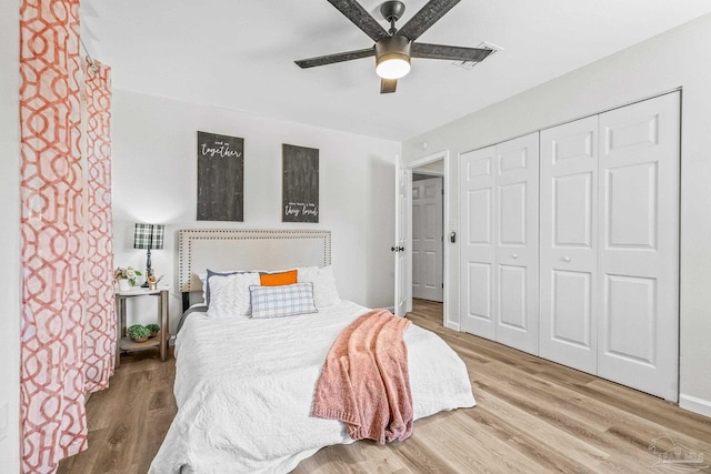 bedroom featuring light wood-type flooring, a closet, and ceiling fan