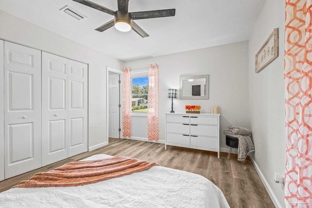 bedroom featuring ceiling fan, a closet, and light hardwood / wood-style flooring