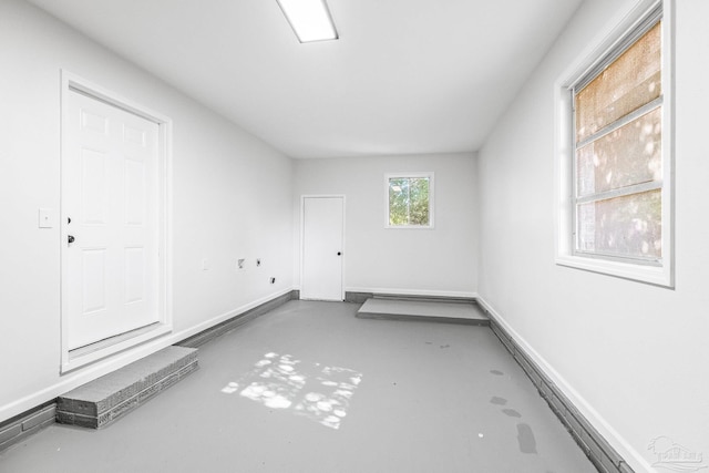 unfurnished room with concrete flooring