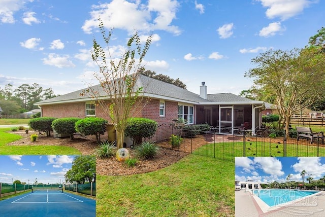 back of house featuring a sunroom, a lawn, and a fenced in pool