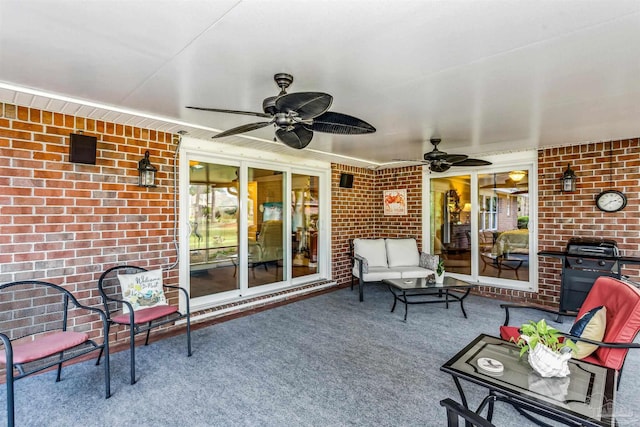 view of patio with area for grilling and ceiling fan