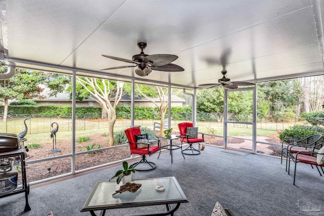 unfurnished sunroom featuring ceiling fan and plenty of natural light