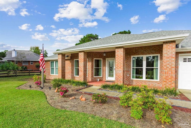 view of front of house featuring a garage and a front yard