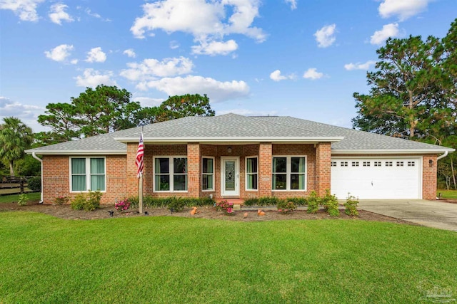 view of front of home with a garage and a front lawn