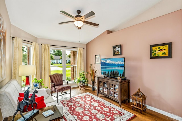 living room featuring lofted ceiling, hardwood / wood-style floors, and ceiling fan