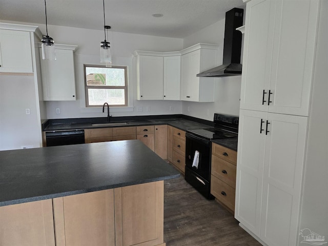 kitchen featuring wall chimney exhaust hood, black appliances, dark countertops, and a sink