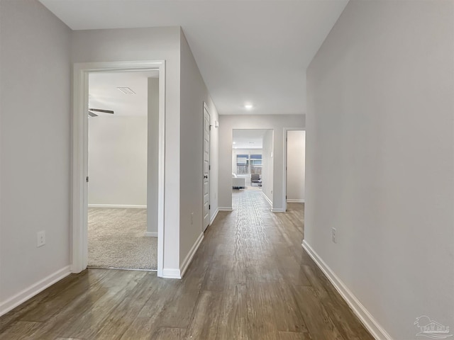 hall with baseboards and dark wood-style floors