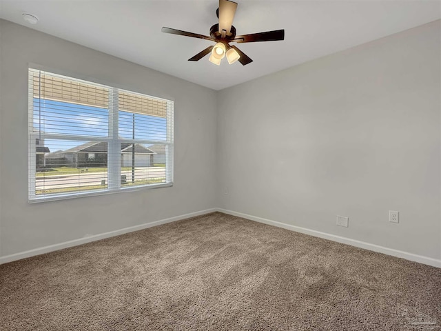 empty room featuring baseboards, carpet, and ceiling fan