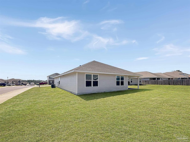 view of property exterior featuring a lawn and fence