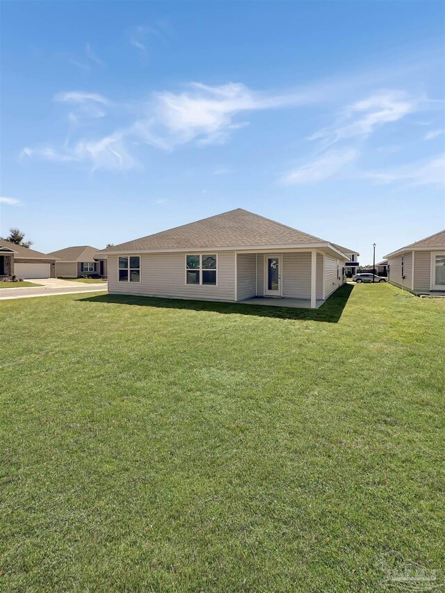 back of house with a lawn