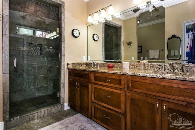 bathroom featuring vanity, a shower with door, and crown molding