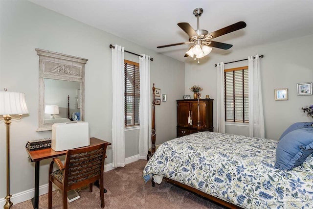 bedroom with ceiling fan, carpet floors, and multiple windows