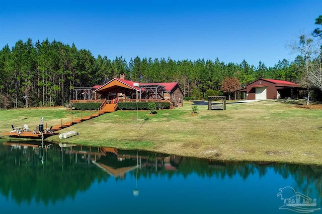 surrounding community featuring a yard, a water view, and an outdoor structure