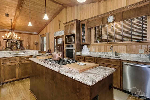 kitchen featuring sink, vaulted ceiling with beams, pendant lighting, wood ceiling, and appliances with stainless steel finishes