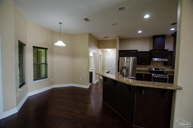 4777 Belvedere Cir, Pace, FL 32571 - kitchen featuring stainless steel appliances, under cabinet range hood, dark wood-type flooring, a kitchen breakfast bar, and baseboards