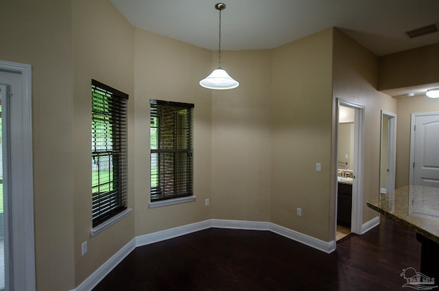 4777 Belvedere Cir, Pace, FL 32571 - unfurnished dining area with dark wood-style floors and baseboards