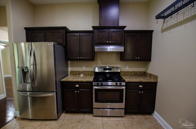 4777 Belvedere Cir, Pace, FL 32571 - kitchen with stainless steel appliances, under cabinet range hood, light stone countertops, and dark brown cabinets