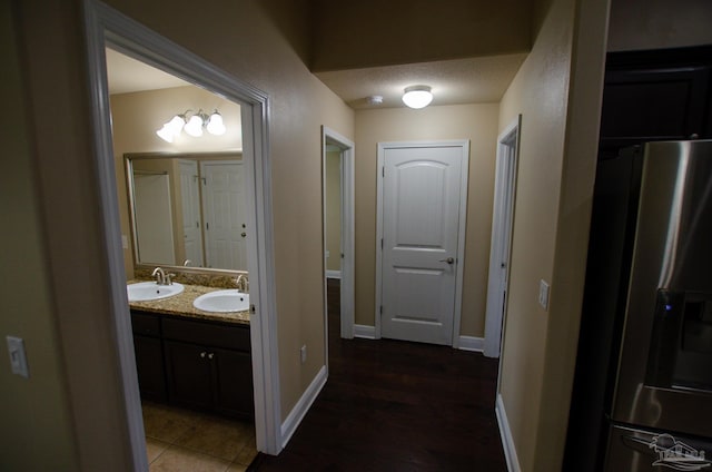 4777 Belvedere Cir, Pace, FL 32571 - bathroom with double vanity, baseboards, and wood finished floors