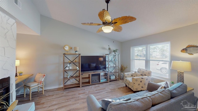 living room featuring light hardwood / wood-style flooring, ceiling fan, and lofted ceiling