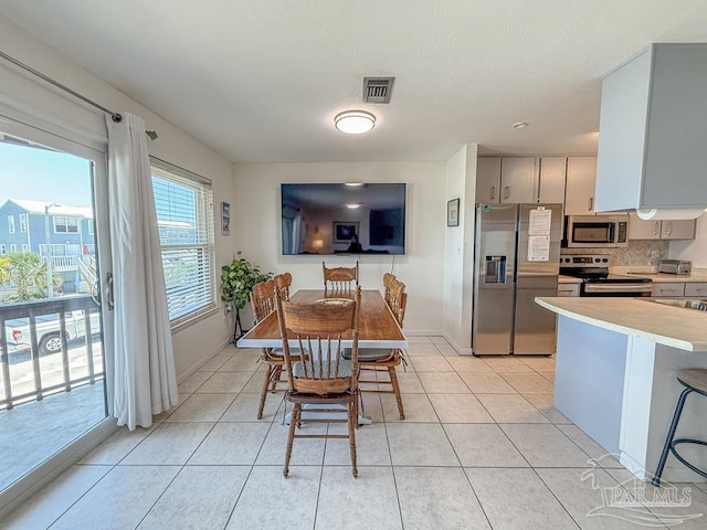 1448 Tina Dr Unit 213, Navarre Beach, FL 32566 - dining room with baseboards and light tile patterned flooring