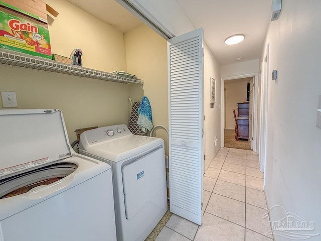 1448 Tina Dr Unit 213, Navarre Beach, FL 32566 - washroom featuring independent washer and dryer and light tile patterned floors