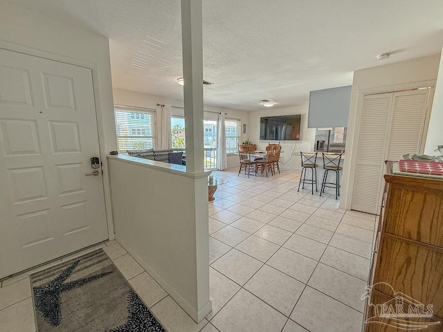 1448 Tina Dr Unit 213, Navarre Beach, FL 32566 - entryway with light tile patterned floors and a textured ceiling