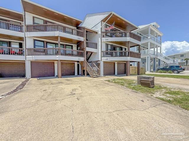 1448 Tina Dr Unit 213, Navarre Beach, FL 32566 - view of front of property with concrete driveway and an attached garage