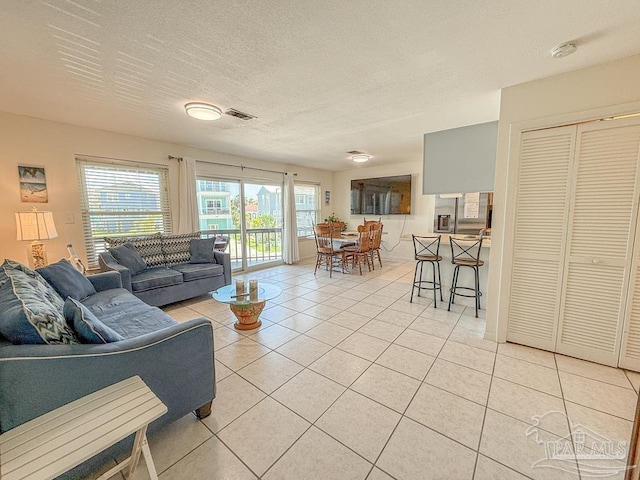 1448 Tina Dr Unit 213, Navarre Beach, FL 32566 - living area with light tile patterned flooring and a textured ceiling